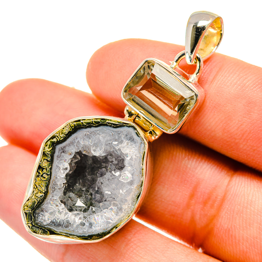 Geode druzy quartz pendant close-up with silver bail and gray crystal surface
