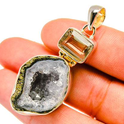 Geode druzy quartz pendant close-up with silver bail and gray crystal surface
