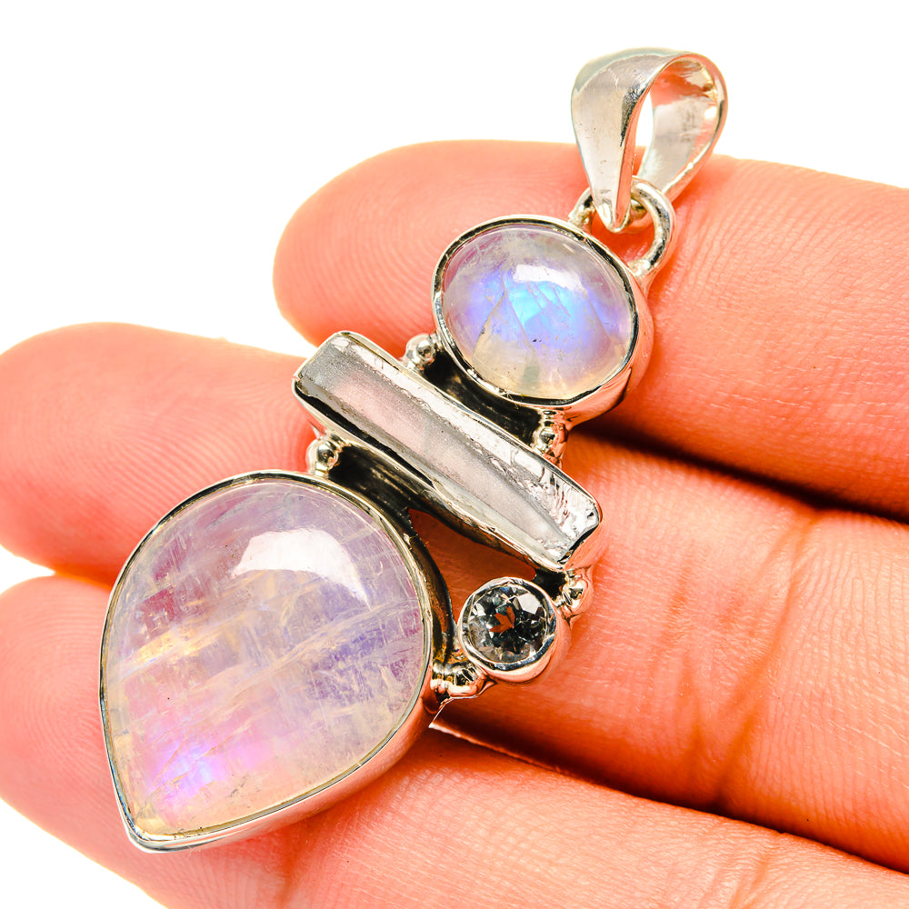 Sterling silver pendant with iridescent oval moonstone cabochons and blue topaz