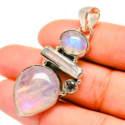 Sterling silver pendant with iridescent oval moonstone cabochons and blue topaz