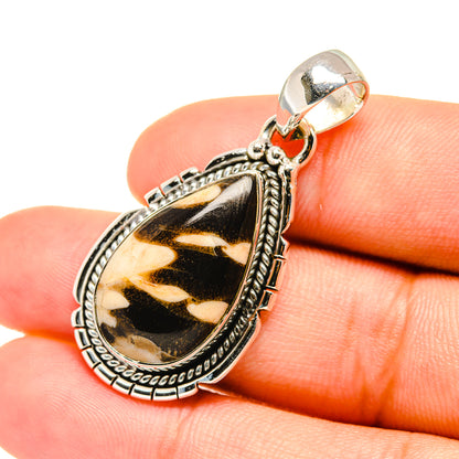 Teardrop jasper pendant close-up with textured silver bail and brown-gold cabochon