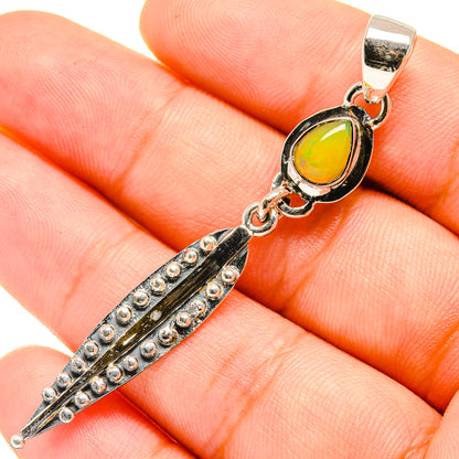Sterling silver opal pendant with oval yellow stone and spike drop, linked bail