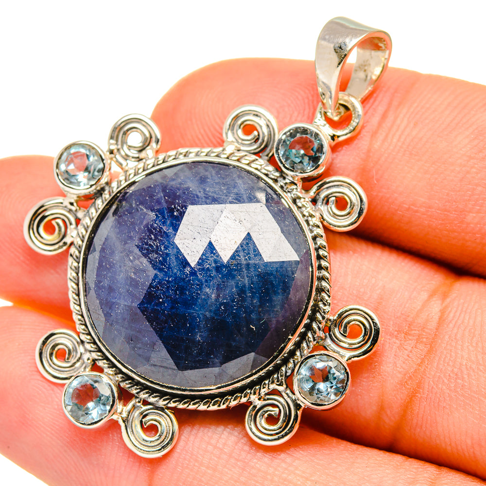 Round blue gemstone pendant in sterling silver ornate bezel with small aqua stones