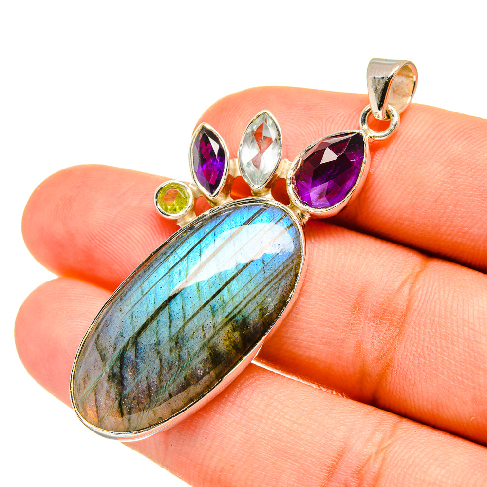 Gemstone pendant with oval labradorite blue and silver setting, purple and green stones
