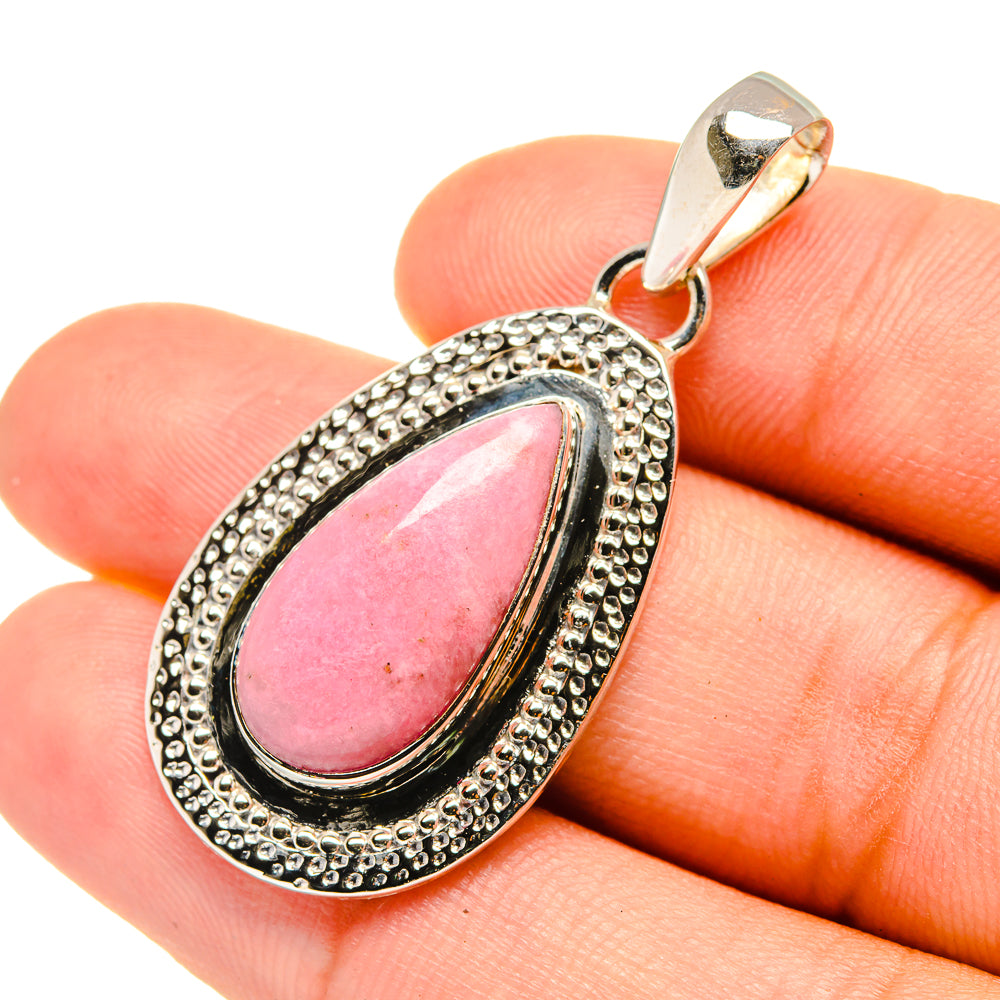 Teardrop pink opal pendant with textured silver frame and loop bail
