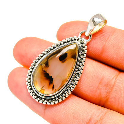 Teardrop sterling silver pendant with amber agate, beaded frame and loop bail on hand