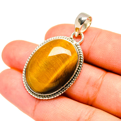 Tiger eye pendant on bail, oval gold-brown stone set in 925 sterling silver frame