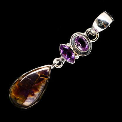 Sterling silver pendant with purple amethyst bezels and a teardrop brown-gold stone