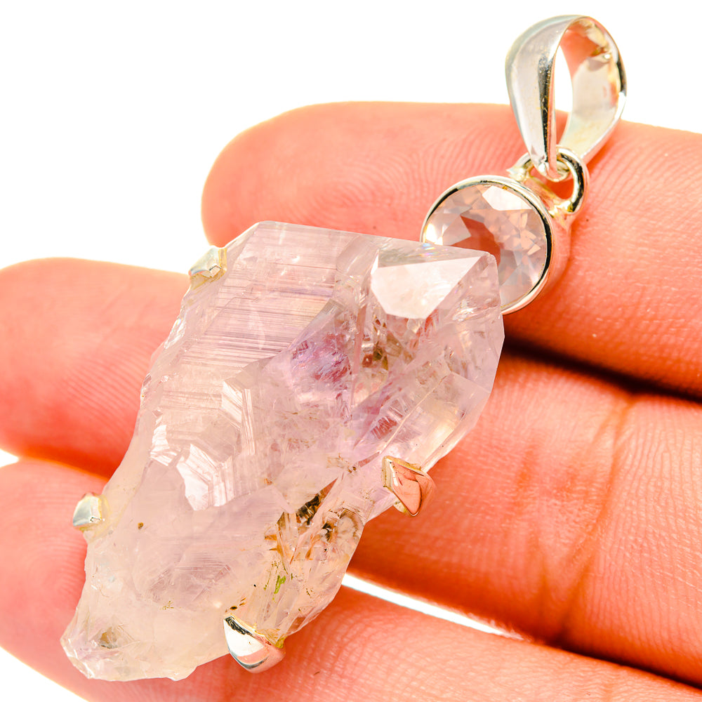 Rose quartz crystal pendant with sterling silver bail and faceted stone