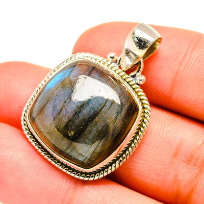 Labradorite pendant close-up with oval stone and textured sterling silver border
