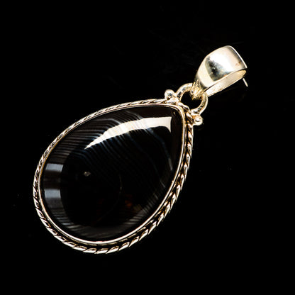 Teardrop pendant with black stone and ornate sterling silver border, loop bail