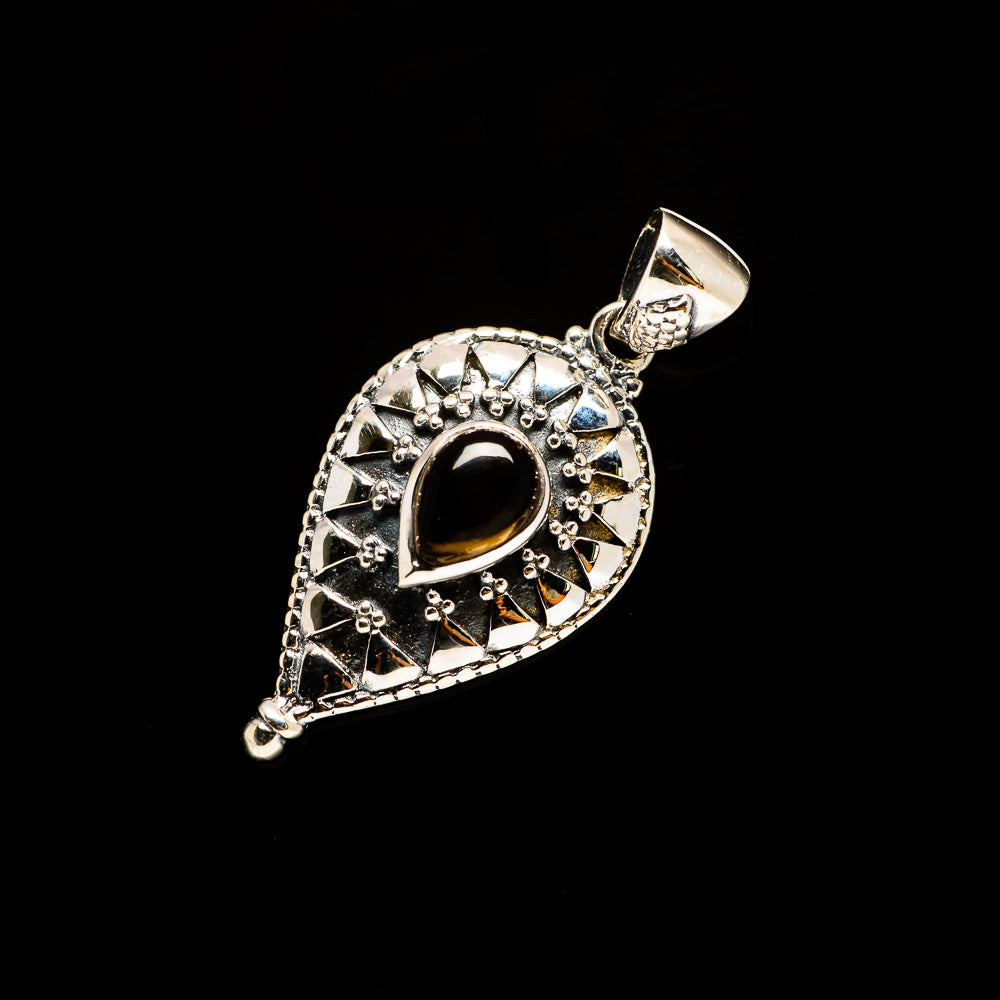 Sterling silver pendant with prong-set dark teardrop gemstone and textured bail