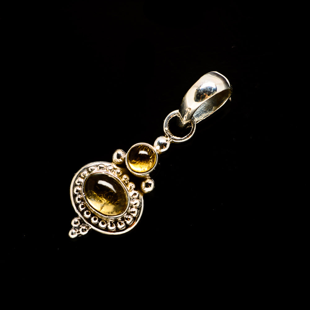 Sterling silver citrine pendant with round yellow gemstone and halo detailing