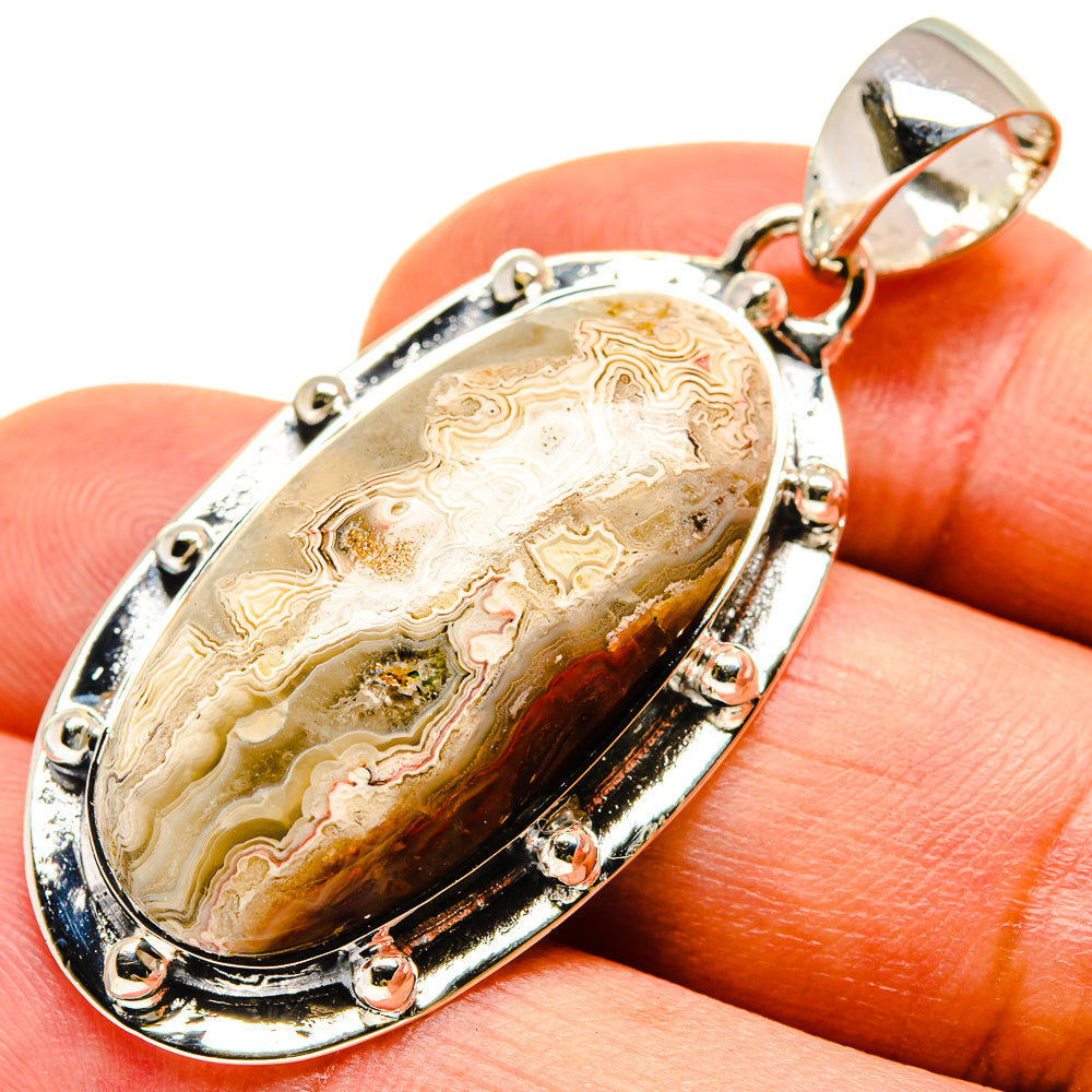 Oval sterling silver agate pendant with faceted bail and lace-like stone pattern