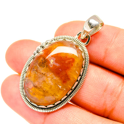Oval orange and amber agate pendant in silver rope bezel with bail
