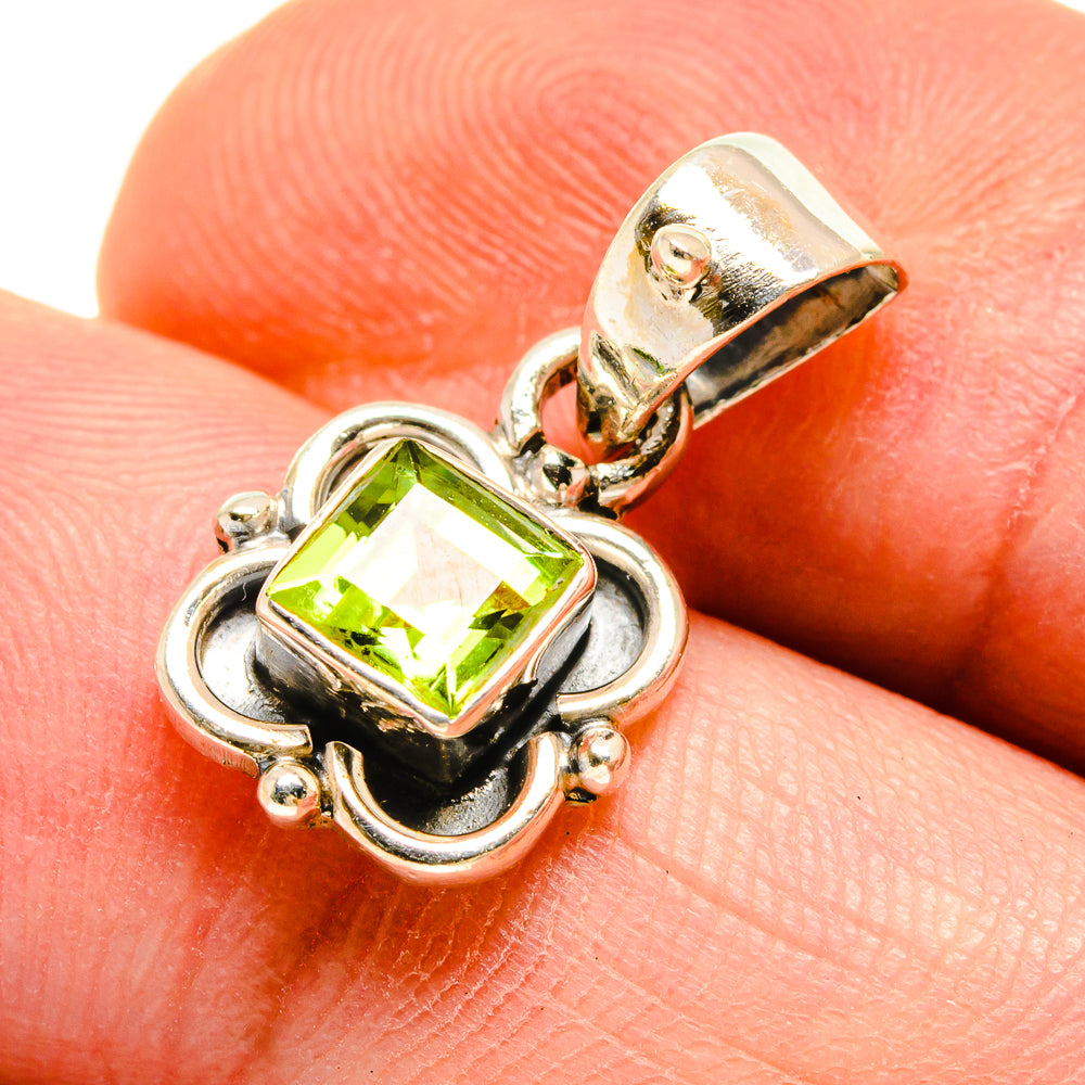 Peridot pendant close-up: square lime-green stone in silver setting on bail