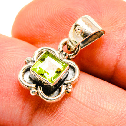 Peridot pendant close-up: square lime-green stone in silver setting on bail