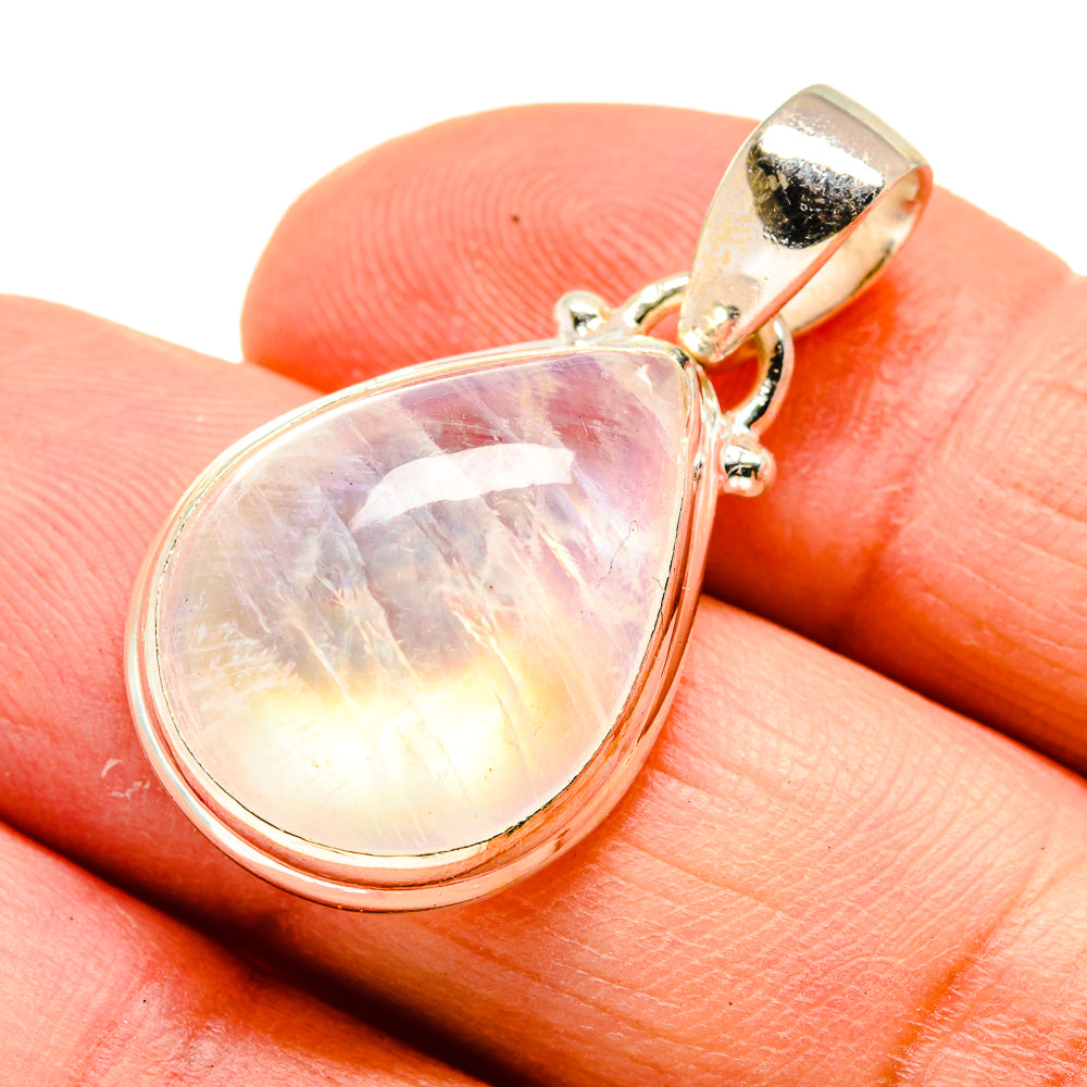 Opalescent moonstone teardrop pendant detail with silver-tone bail and setting.