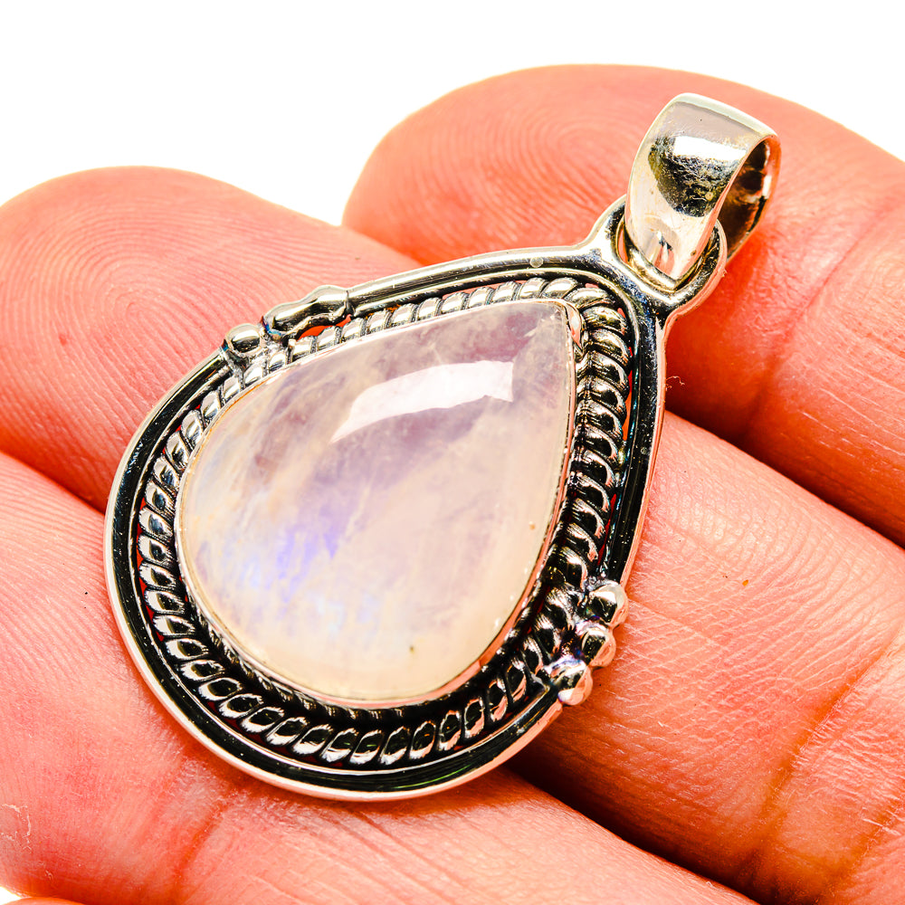 Moonstone pendant teardrop bezel with ornate silver edging and bail, pale lavender opalescence.