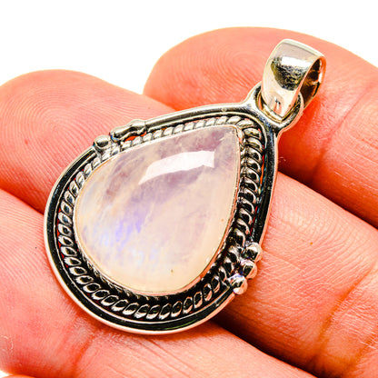 Moonstone pendant teardrop bezel with ornate silver edging and bail, pale lavender opalescence.