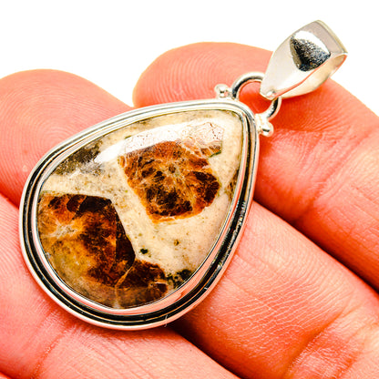 Muscovite pendant with teardrop orange-brown stone in silver bezel and bail