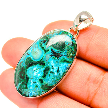 Oval turquoise-green stone pendant with silver bezel and polished bail