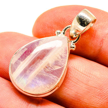 Teardrop moonstone pendant in silver with ornate bail and iridescent rainbow sheen