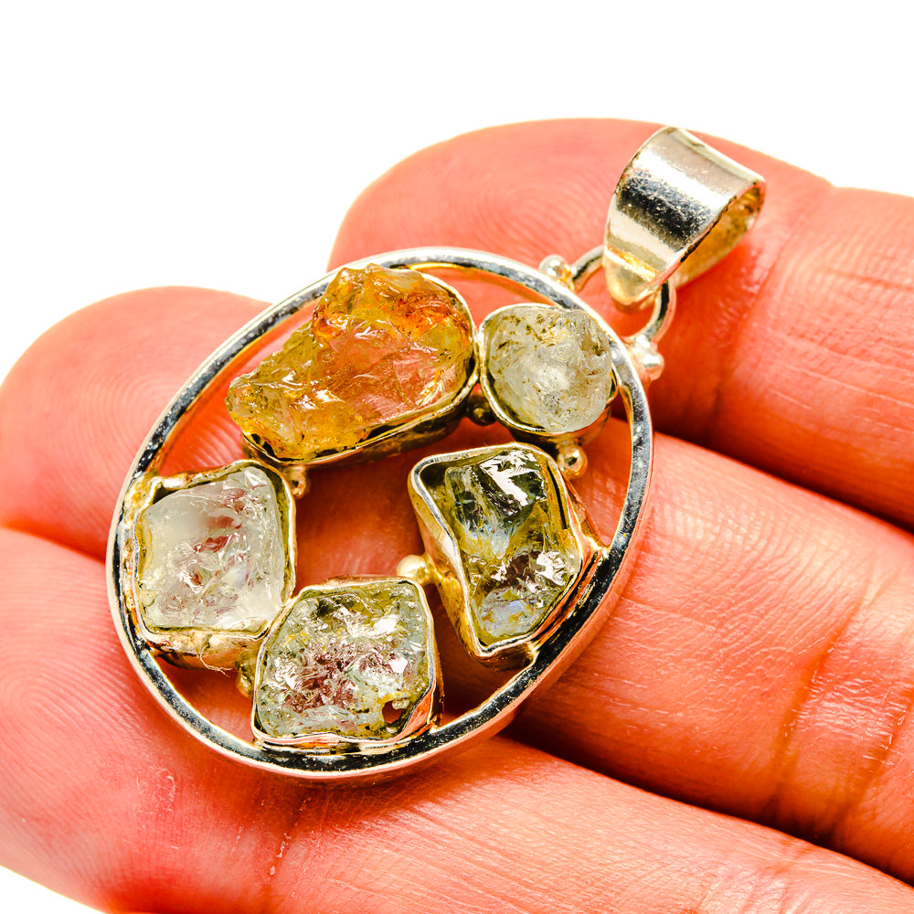 Sterling silver pendant with round bezel and bail, mixed amber and pale green rough stones