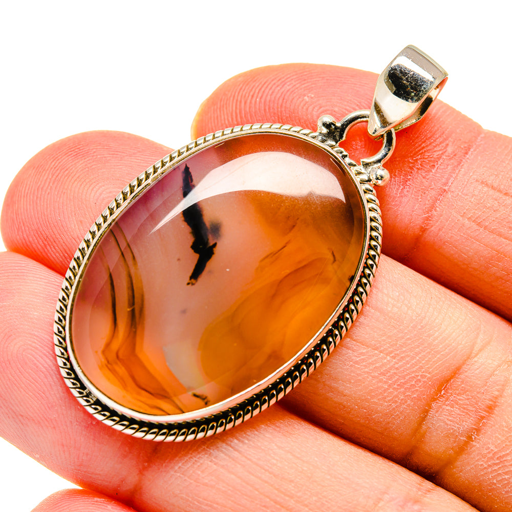 Oval Montana agate pendant with amber-brown stone, rope bezel, and silver bail
