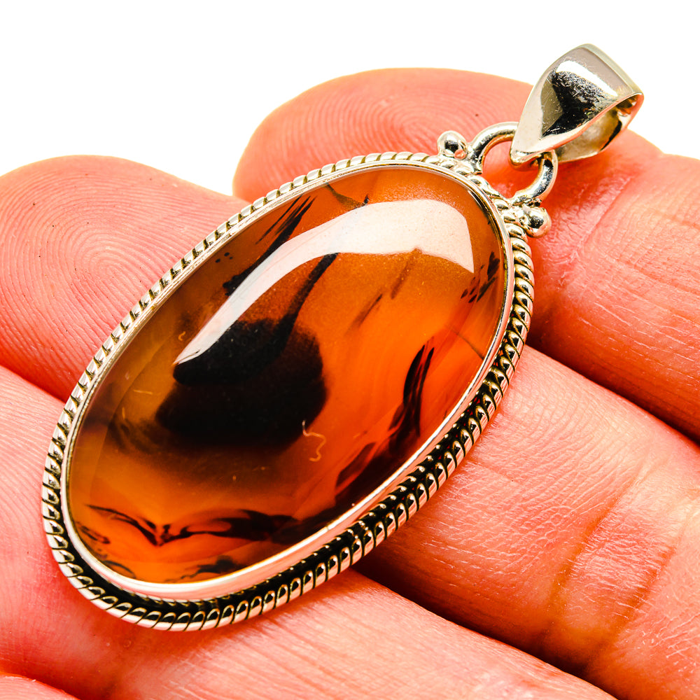 Sterling silver agate pendant with amber-orange teardrop stone and loop bail