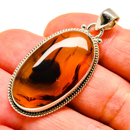Sterling silver agate pendant with amber-orange teardrop stone and loop bail