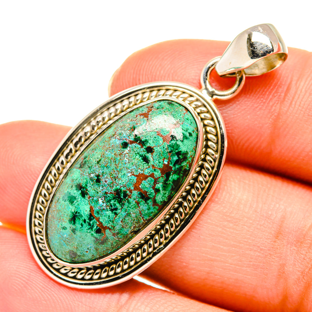 Oval turquoise pendant with ornate sterling silver bezel and bail on top loop