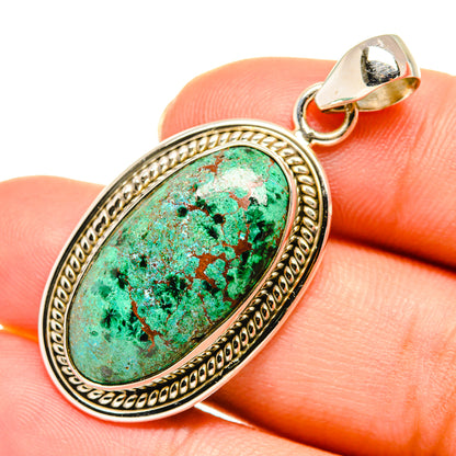 Oval turquoise pendant with ornate sterling silver bezel and bail on top loop