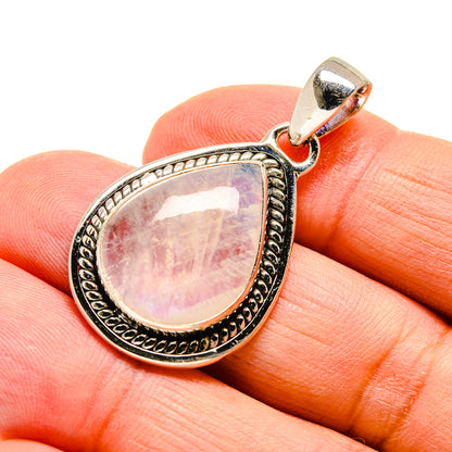 Teardrop moonstone pendant with gold-tone bezel and bail, pink-lavender iridescent stone