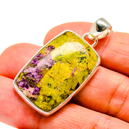 Sterling silver pendant on fingers with rectangular stone in yellow, green, and purple