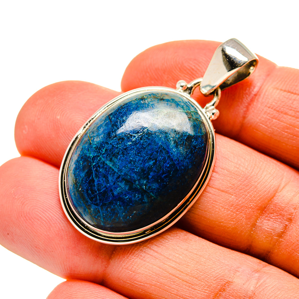 Oval blue chrysocolla quartz pendant with silver bezel and bail, close-up