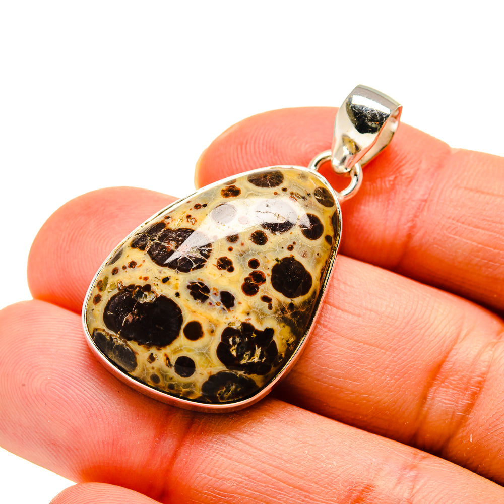 Heart-shaped poppy jasper pendant with black speckled pattern and silver bezel bail