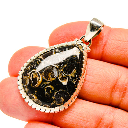 Teardrop agate pendant with black and gold swirl in sterling silver bezel and bail