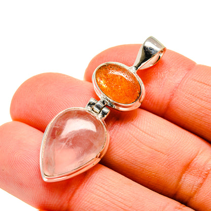 Silver double-stone pendant close-up with pink rose quartz and orange sunstone cabochons