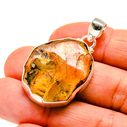 Rough opal pendant in sterling silver bezel with looped bail, warm orange and gold tones
