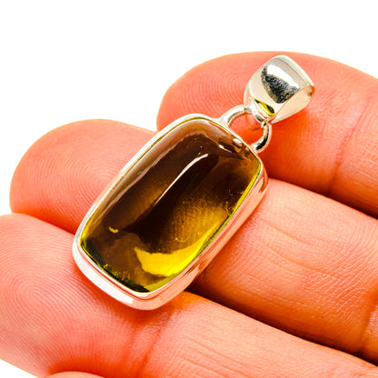 Quartz pendant in silver setting with olive-brown polished stone cabochon