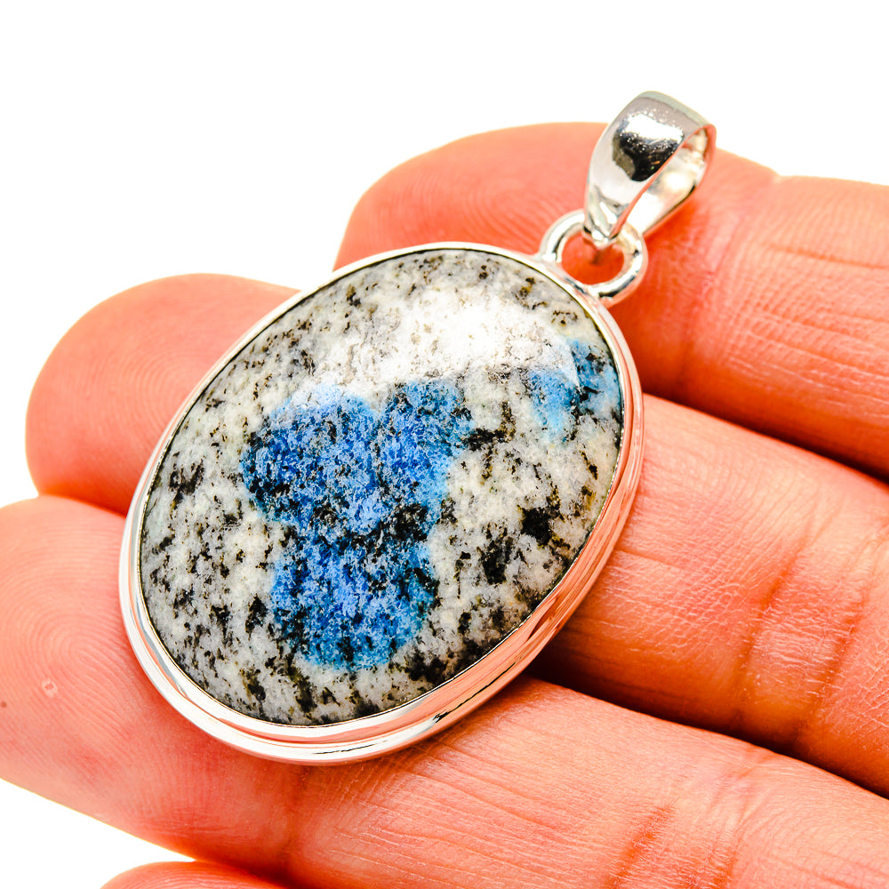 Oval pendant with blue mineral on white matrix set in silver-tone frame