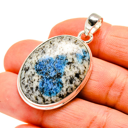 Oval pendant with blue mineral on white matrix set in silver-tone frame