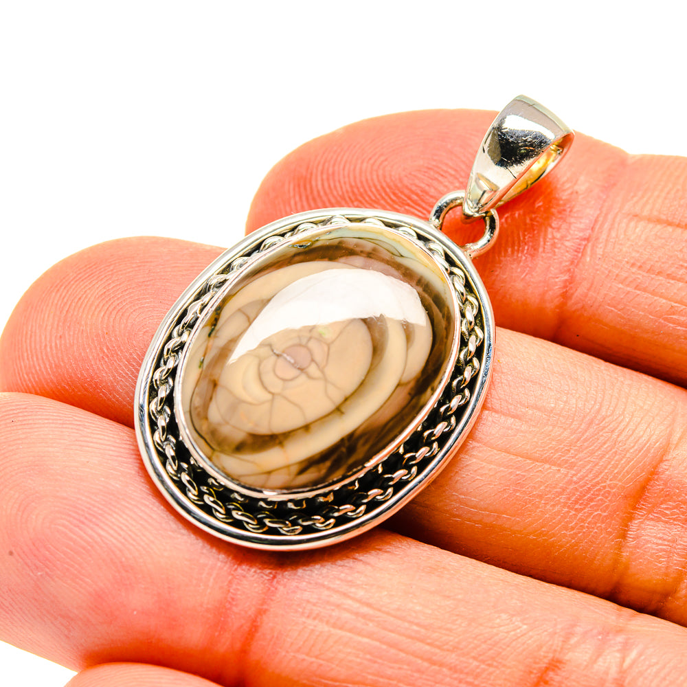 Oval jasper pendant in sterling silver with ornate border and loop bail, cream-brown stone