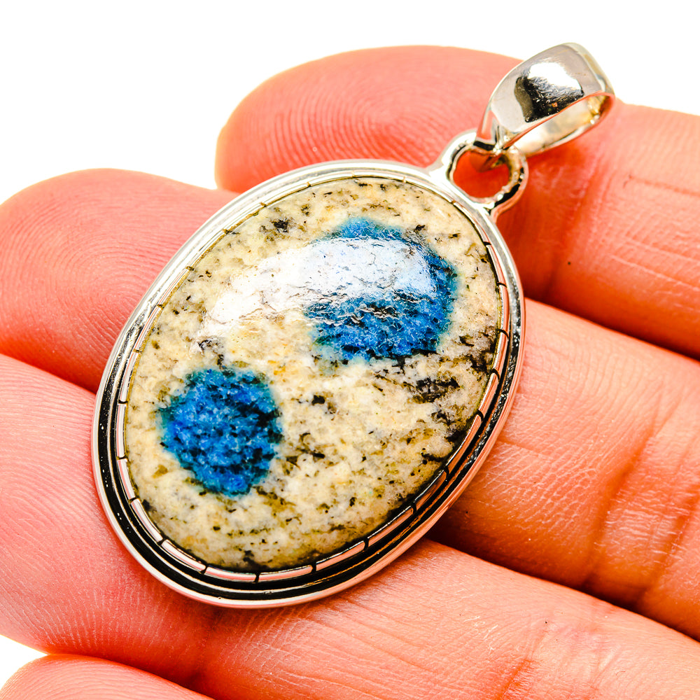 Oval sterling silver pendant with blue azurite cabochon and textured bail loop