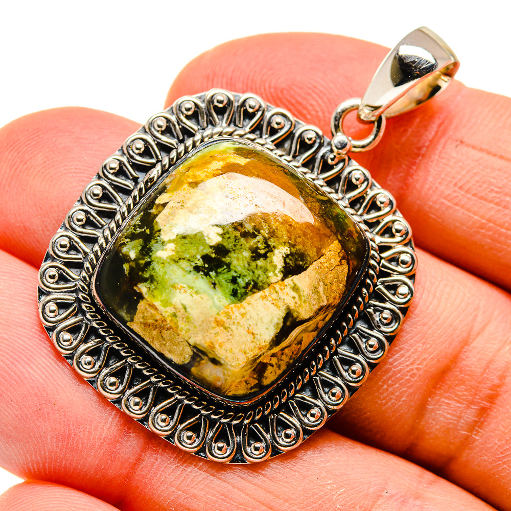 Oval green opal pendant in ornate sterling silver bezel with gold-toned bail