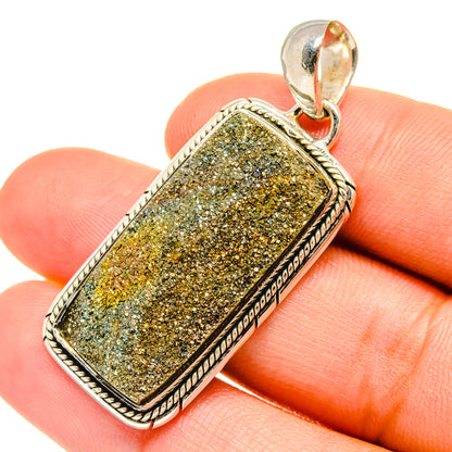 Druzy pyrite pendant in rectangular bezel with silver border and bail, yellow-gold sparkle.
