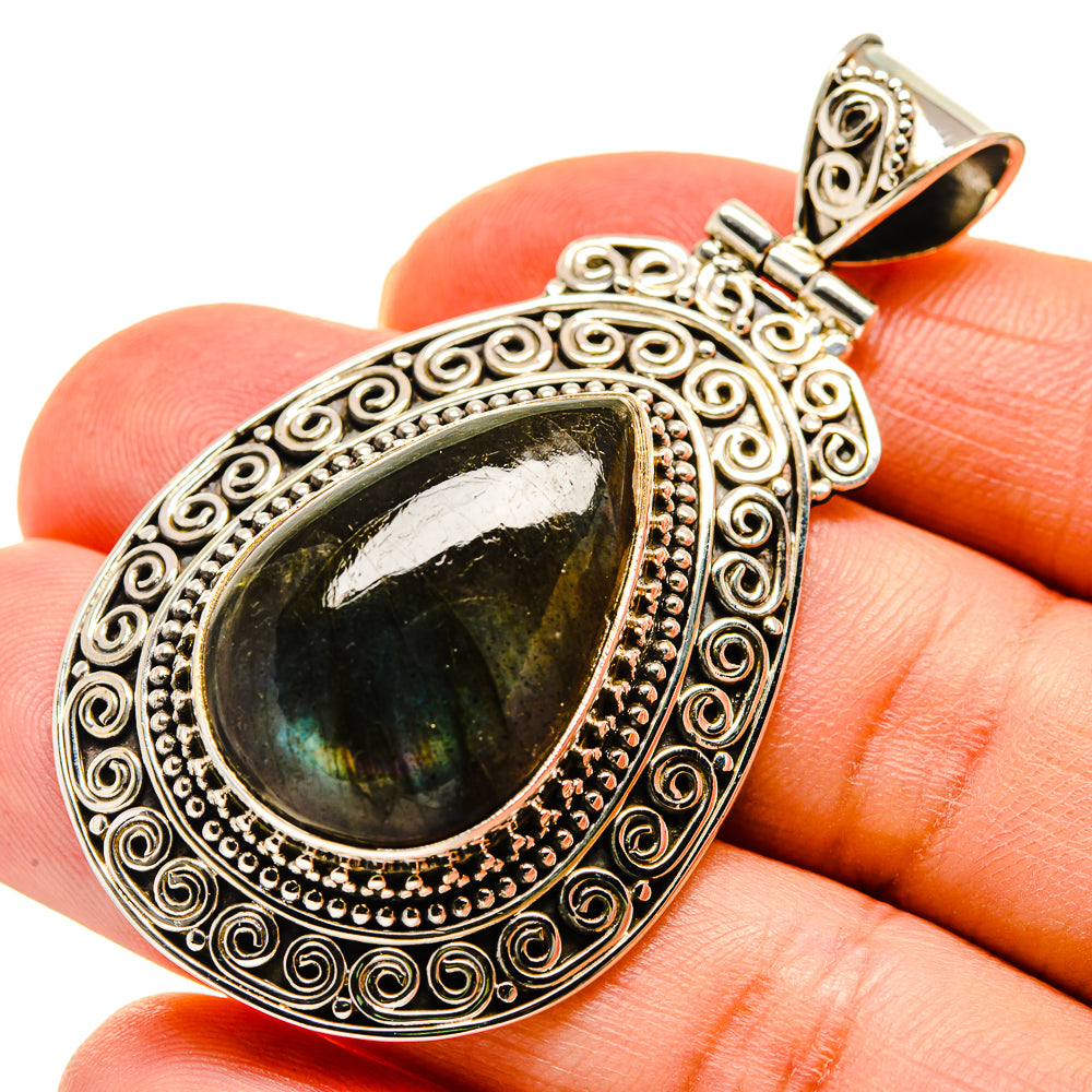 Labradorite teardrop pendant in ornate sterling silver setting with dark green flash