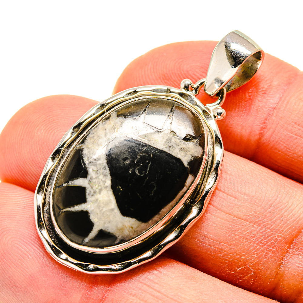 Septarian geode pendant in oval bezel with black-and-white stone, silver-tone bail