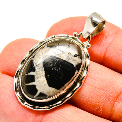 Septarian geode pendant in oval bezel with black-and-white stone, silver-tone bail